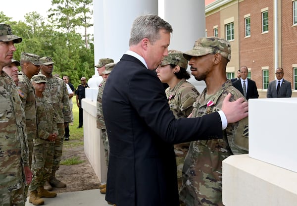 U.S. Army Secretary Dan Driscoll speaks with Sgt. Aaron Turner after Turner received the Meritorious Service Medal with five other soldiers outside Fort Stewart in Georgia, Thursday, Aug. 6, 2025. (Hyosub Shin /Atlanta Journal-Constitution via AP)