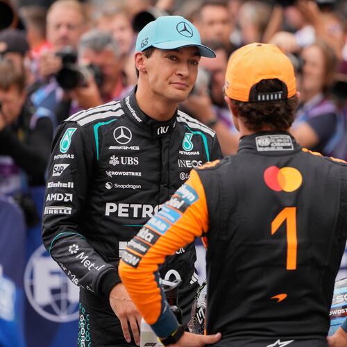 Mercedes driver George Russell of Britain, left, atlks to McLaren driver Lando Norris of Britain after the qualifying for the Formula One Dutch Grand Prix in Zandvoort , Netherlands, Saturday, Aug. 22, 2026. (AP Photo/Darko Bandic)