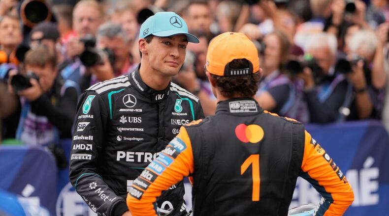Mercedes driver George Russell of Britain, left, atlks to McLaren driver Lando Norris of Britain after the qualifying for the Formula One Dutch Grand Prix in Zandvoort , Netherlands, Saturday, Aug. 22, 2026. (AP Photo/Darko Bandic)