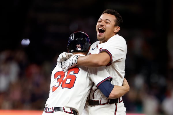 Braves catcher Drake Baldwin (right) celebrates his walk-off hit with teammate Eli White. (Butch Dill/AP)