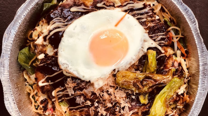 OK Yaki’s large okonomiyaki-yakisoba combo is seen here, with pork belly and fried egg added. The noodles (with added veggies) are under the pancake. CONTRIBUTED BY WENDELL BROCK