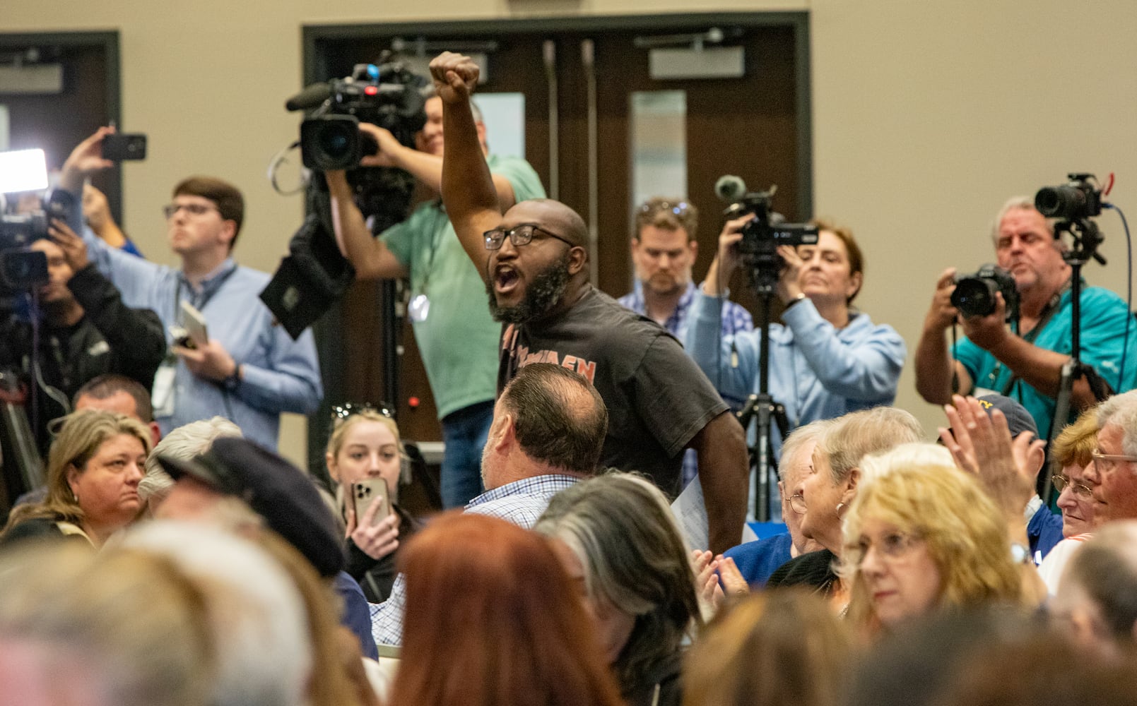 Majorie Taylor Greene holds a town hall at the Acworth Community Center on Tuesday, April 15, 2025. Protestors lined the street outside and disrupted the meeting multiple times.  (Jenni Girtman for The Atlanta Journal-Constitution)