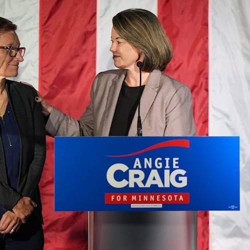 U.S. Rep. Angie Craig, D-Minn., right, candidate for U.S Senate, stands on stage next to her wife Cheryl Greene during an election night event on Tuesday, Aug. 11, 2026, in St. Paul, Minn. (AP Photo/Abbie Parr)