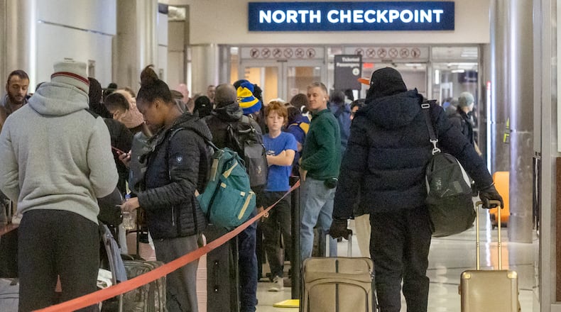 Early morning travelers wait in line to check in at the Southwest counter at at Hartsfield-Jackson International Airport Saturday, Dec. 24, 2022. Those heading out to the airport or elsewhere in metro Atlanta faced temperatures in the single digits Saturday morning. (Photo: Steve Schaefer / steve.schaefer@ajc.com)