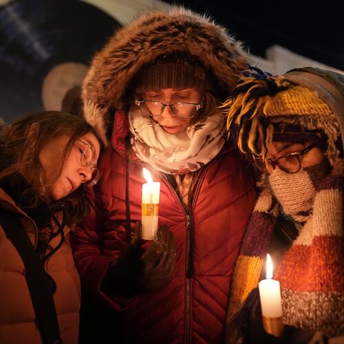 People attend a vigil where Alex Pretti was shot and killed by federal immigration enforcement in Minneapolis, on Wednesday, Jan. 28, 2026. (AP Photo/Adam Gray)