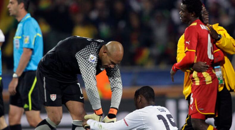 United States goalkeeper Tim Howard, left, helps United States' Maurice Edu, bottom, get up at the end of the World Cup round of 16 soccer match between the United States and Ghana at Royal Bafokeng Stadium in Rustenburg, South Africa, Saturday, June 26, 2010. Ghana won 2-1, advancing to the World Cup quarterfinals.