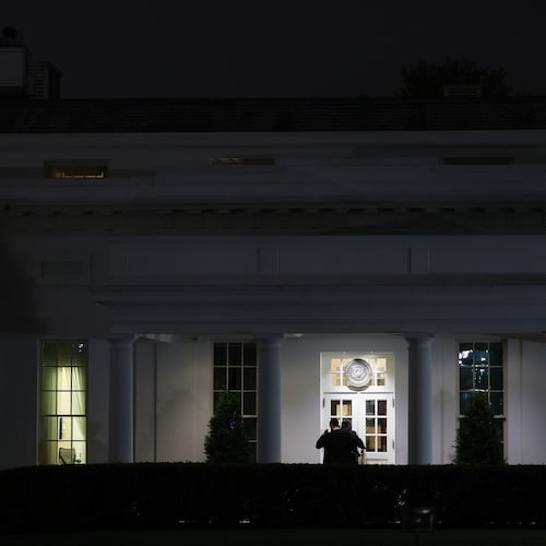 People are seen outside the West Wing driveway entrance of the White House, Saturday, April 25, 2026, in Washington. (AP Photo/Tom Brenner)