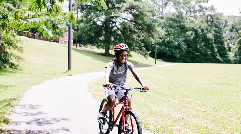 Tuskegee Airmen Global Academy families participating in the Atlanta Bicycle Coalition's 2019 Bike Family cohort. Participants received bikes and bike safety gear and participated in bike safety classes as part of Atlanta Bicycle Coalition’s Bike Family program. Courtesy of Atlanta Bicycle Coalition