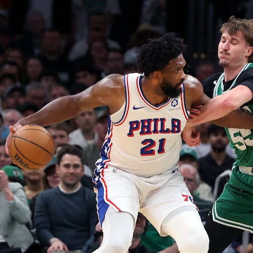Boston Celtics' Jayson Baylor Scheierman (right) defends agianst Philadelphia 76ers' Joel Embiid (left) during the first half of Game 7 in a first-round NBA basketball playoffs series, Saturday, May 2, 2026 in Boston. (AP Photo/Jim Davis)