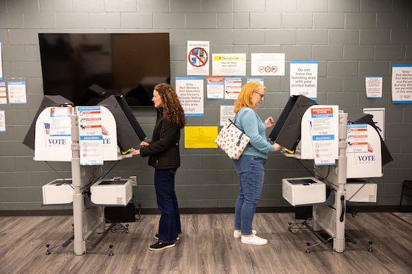 Julie Garrison (left) and Jennifer Pennington cast votes in a runoff special election at the Buzz Ahrens Recreation Center in Canton in January. (Arvin Temkar/AJC)