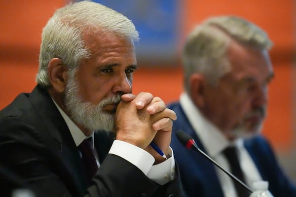 Dr. Robert Malone, left, listens during a meeting of the Advisory Committee in Immunization Practices at the CDC, Wednesday, June 25, 2025, in Atlanta. (AP Photo/Mike Stewart)