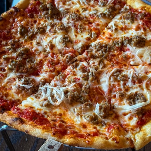 The K.R.O.G. pizza at chef Kevin Rathbun's Krog Bar, is made with fennel sausage, onions and mozzarella. (Henri Hollis/AJC)