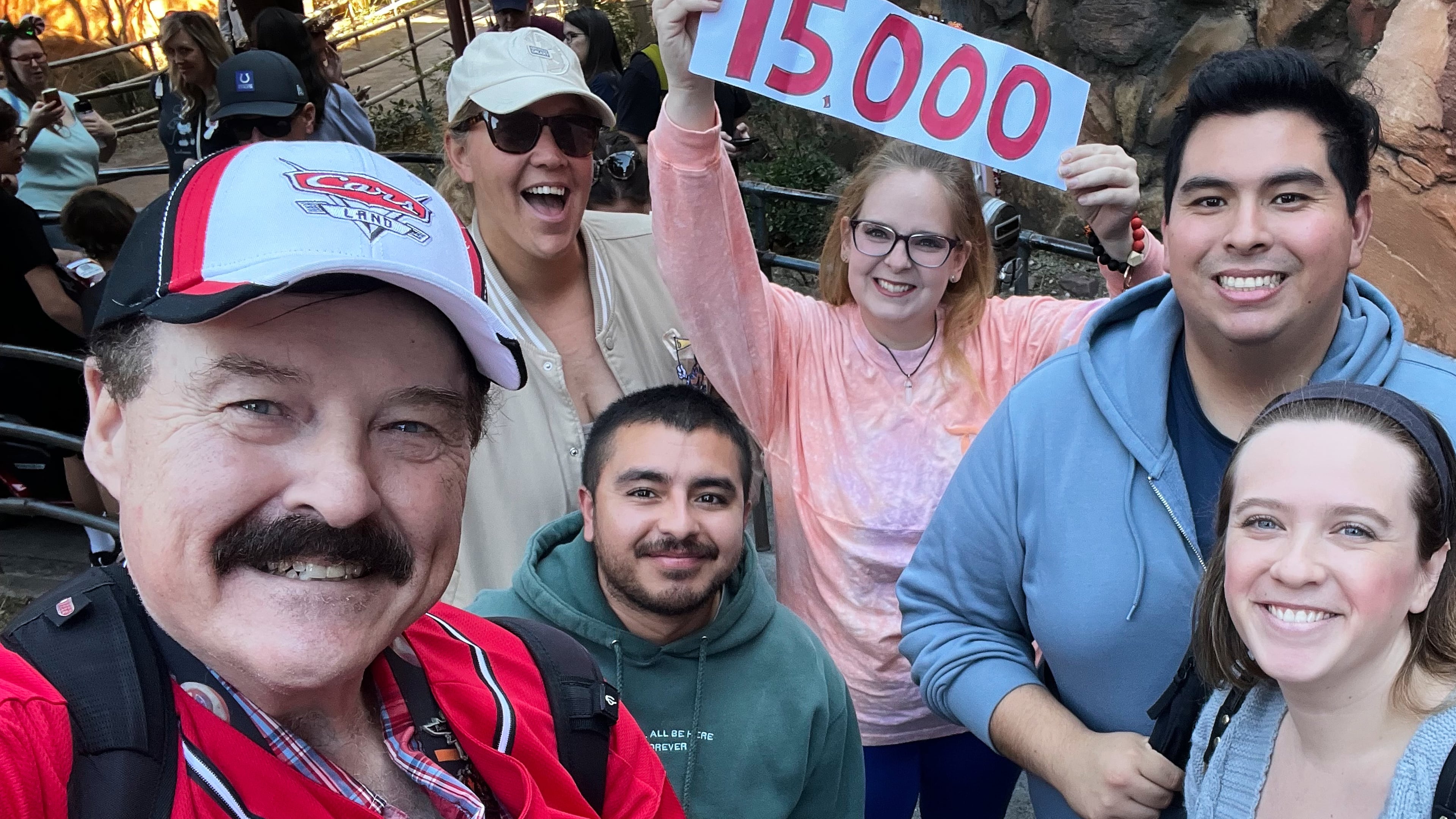 In this photo provided by Jon Alan Hale, Hale, left, poses with friends after taking his 15,000th Radiator Springs Racers ride at Disney California Adventure in Anaheim, Calif., Monday, Dec. 8, 2025. (Jon Alan Hale via AP)
