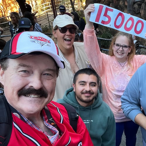 In this photo provided by Jon Alan Hale, Hale, left, poses with friends after taking his 15,000th Radiator Springs Racers ride at Disney California Adventure in Anaheim, Calif., Monday, Dec. 8, 2025. (Jon Alan Hale via AP)