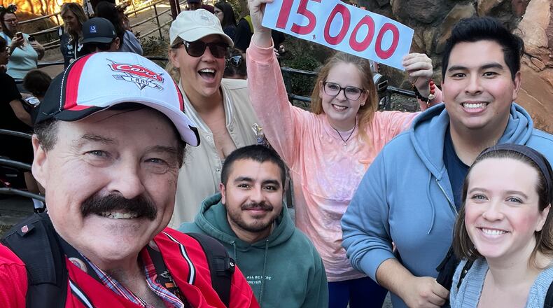 In this photo provided by Jon Alan Hale, Hale, left, poses with friends after taking his 15,000th Radiator Springs Racers ride at Disney California Adventure in Anaheim, Calif., Monday, Dec. 8, 2025. (Jon Alan Hale via AP)
