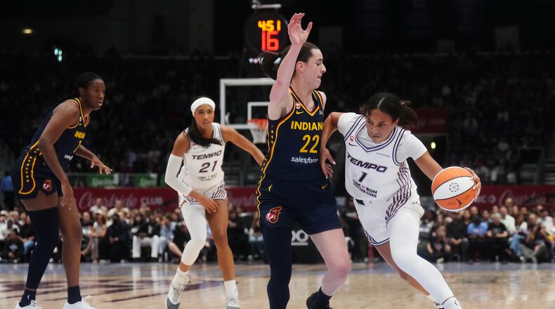 Toronto Tempo's Teonni Key, right, drives as Indiana Fever's Caitlin Clark (22) defends during the first half of a WNBA basketball game in Toronto, Friday, Sept. 18, 2026. (Nathan Denette/The Canadian Press via AP)
