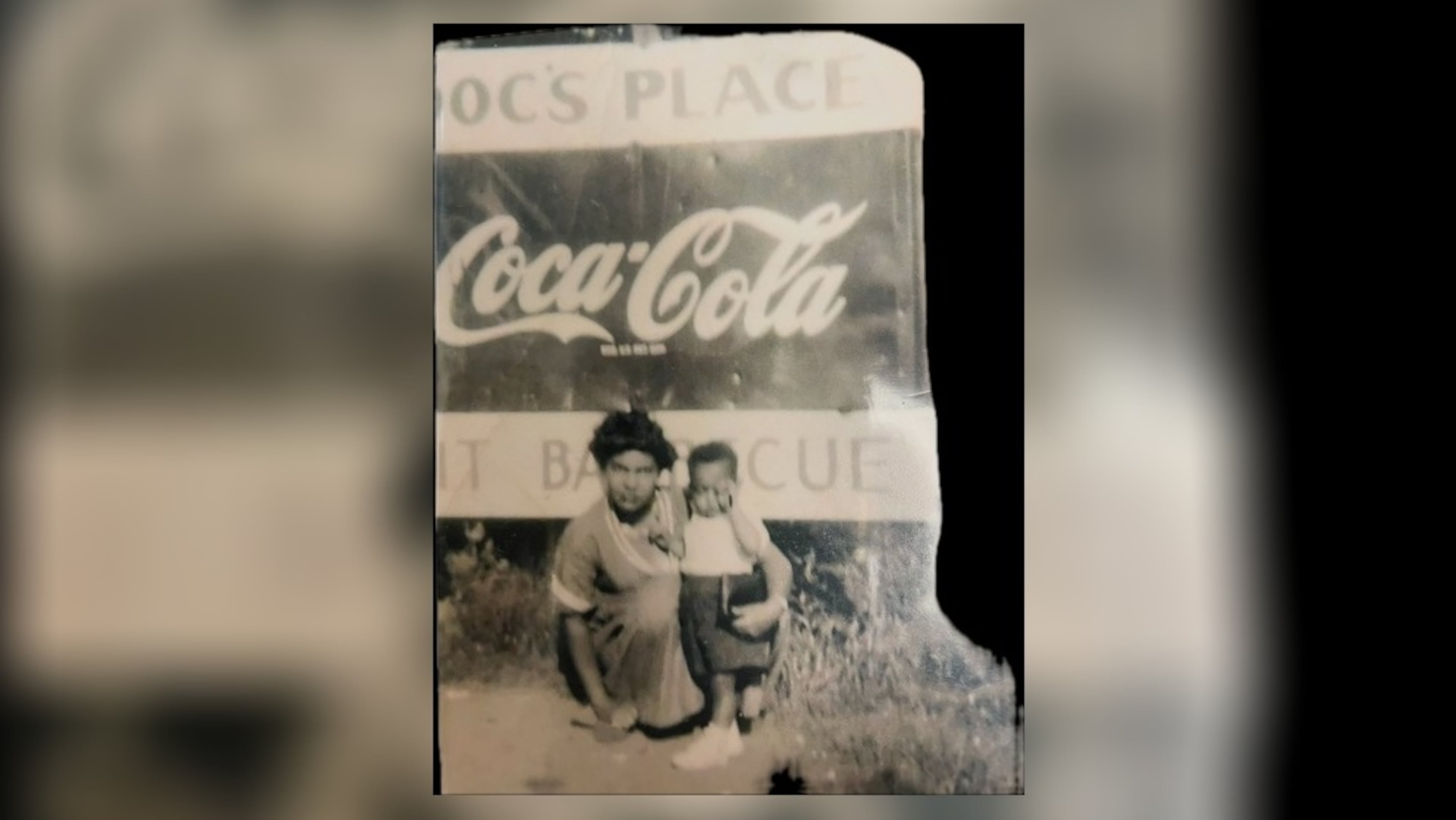 Ann Strickland and her son, Morris, pose in front of Doc’s Café, also known as Doc's Place, in the mid-1950s. (Courtesy of Sabin Strickland)