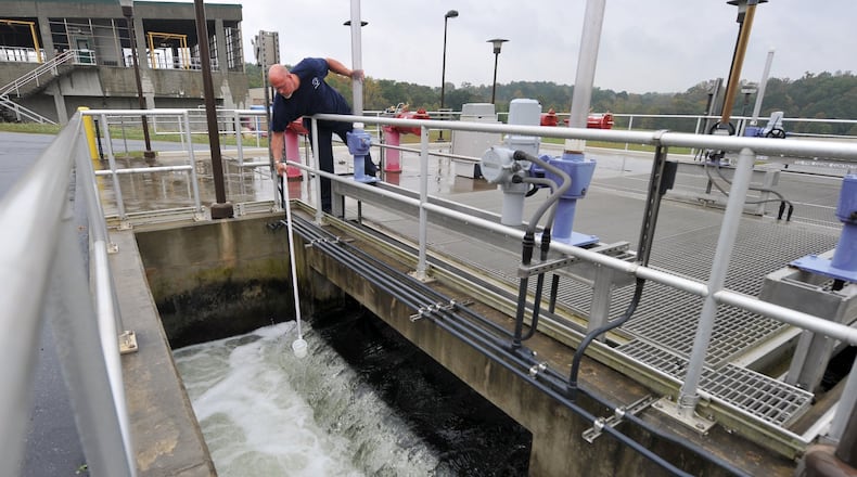 October 17, 2013 Buford, GA: Mark Turner, wastewater manager at the F. Wayne Hill Water Resources Center in Buford, GA, pulls a sample of water leaving one of the filtration stations Thursday October 17, 2013. The high tech plant treats around 35 million gallons of water per day, the clean water is then released into Lake Lanier and the Chattahoochee River. BRANT SANDERLIN /BSANDERLIN@AJC.COM