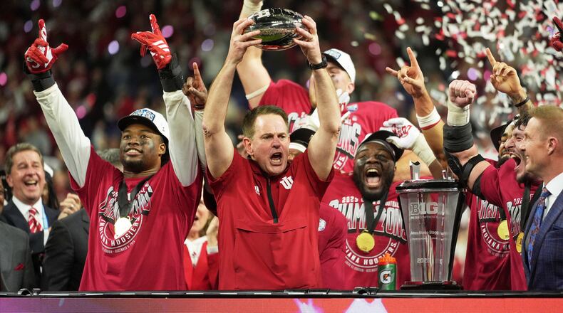 Indiana head coach Curt Cignetti holds up the championship trophy after the Big Ten championship NCAA college football game against Ohio State in Indianapolis, Saturday, Dec. 6, 2025. (AP Photo/Michael Conroy)
