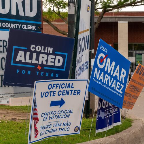 Candidate signs line the entrance to the Oak Lawn Branch Library polling location as voters cast ballots in local and primary runoff elections Tuesday, May 26, 2026, in Dallas. (AP Photo/Gabriela Passos)