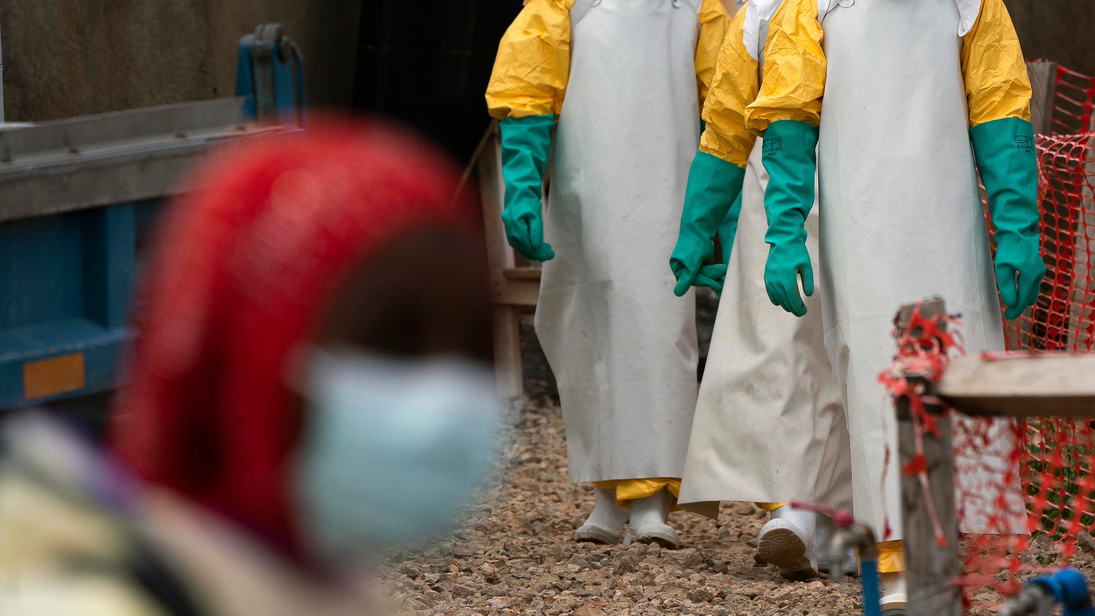 FILE - Health workers dressed in protective gear begin their shift at an Ebola treatment center in Beni, Congo DRC, Tuesday, July 16, 2019. (AP Photo/Jerome Delay, File)