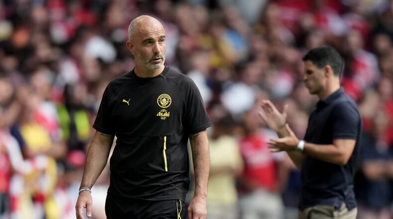Manchester City's head coach Enzo Maresca, left, and Arsenal's manager Mikel Arteta react during the FA Community Shield final soccer match between Arsenal and Manchester City in Cardiff, Wales, Sunday, Aug.16, 2026. (AP Photo/Alastair Grant)