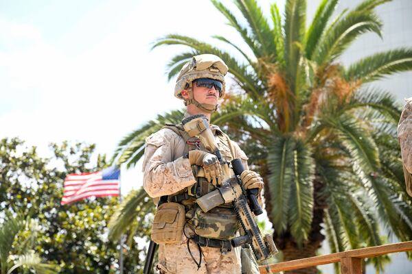 A U.S Marine guards a federal building, Friday, June 13, 2025, in Los Angeles (AP Photo/Noah Berger)