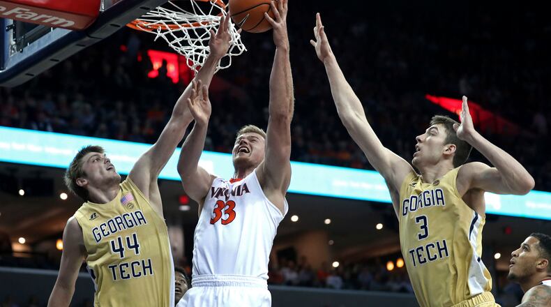 Virginia's Jack Salt (33) shoots between Georgia Tech's Ben Lammers (44) and Evan Cole (3) during the first half of an NCAA college basketball game Wednesday, Feb. 21, 2018, in Charlottesville, Va. (Zack Wajsgras/The Daily Progress via AP)