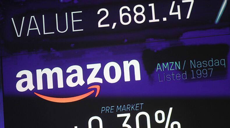 The Nasdaq Composite Index reached a record high Thursday, led by gains at Amazon and optimism about the U.S.-China trade agreeement.