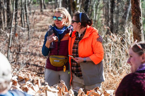 Kate Morris (left), Charles Hosch's law partner, hugs Cat Hosch, Charles' daughter, on Blood Mountain on Saturday as more than 100 volunteers continued the search for Charles Hosch. (Abbey Cutrer/AJC)