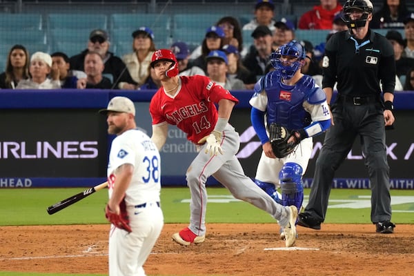 Los Angeles Angels' Logan O'Hoppe, second from left, heads to first for a three-run home run as Los Angeles Dodgers relief pitcher Kirby Yates, left, and catcher Dalton Rushing watches during the seventh inning of a baseball game Saturday, May 17, 2025, in Los Angeles. (AP Photo/Mark J. Terrill)