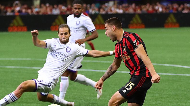 Atlanta United forward Hector Villalba takes a shot on goal past Orlando City defender Alex De John on Sunday, May 12, 2019, at Mercedes-Benz Stadium in Atlanta.