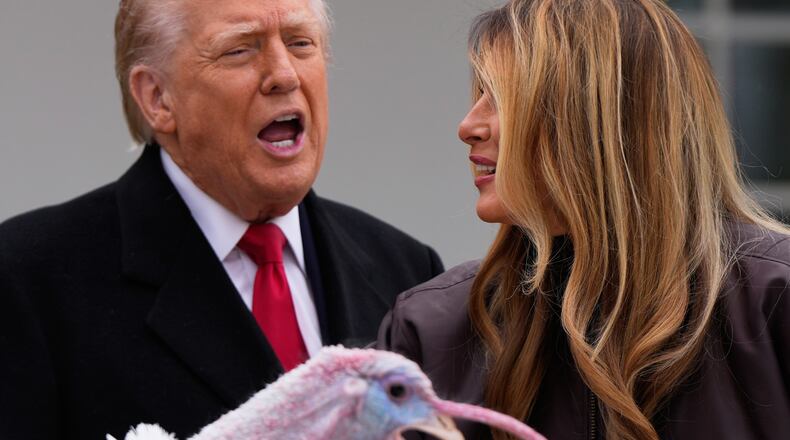 President Donald Trump and first lady Melania Trump, stand next to national Thanksgiving turkey Gobble during a pardoning ceremony in the Rose Garden of the White House, Tuesday, Nov. 25, 2025, in Washington. (AP Photo/Julia Demaree Nikhinson)