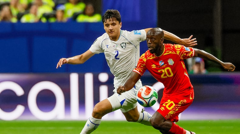 Uzbekistan defender Abdukodir Khusanov (left) chases Congo forward Yoane Wissa (right) across midfield during the first half of a FIFA World Cup match at Atlanta Stadium (Mercedes-Benz Stadium) on Saturday, June 27, 2026, in Atlanta. (Miguel Martinez/AJC)