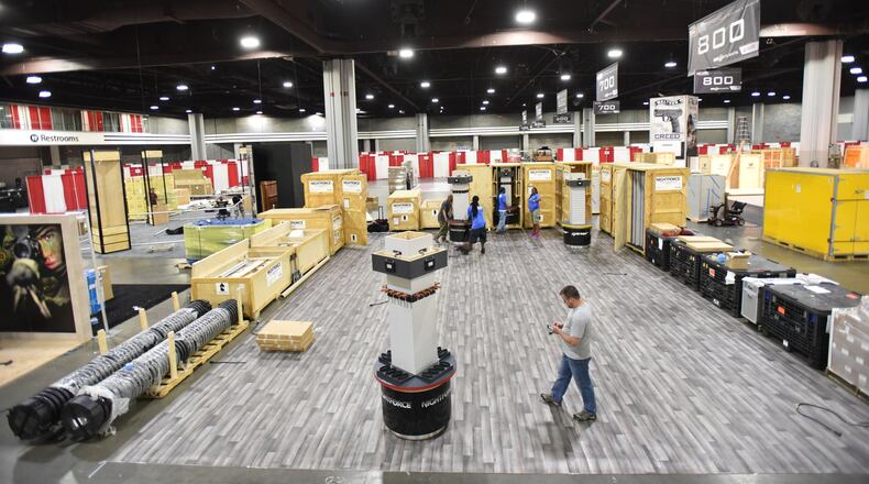 Workers put the finishing touches on the convention floor at the Georgia World Congress Center in preparation for The 146th NRA Annual Meetings and Exhibits in Atlanta. More than 80,000 people are set to attend the NRA convention, which kicks off in Atlanta on Thursday evening and continues through Sunday. HYOSUB SHIN / HSHIN@AJC.COM