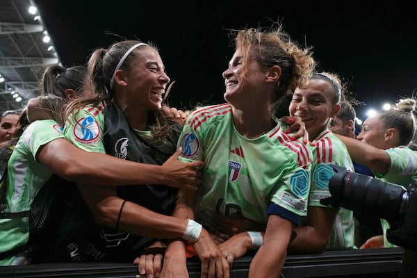 Italy's Cristiana Girelli, center right, celebrates after scoring her side's second goal during the Women's Euro 2025 quarterfinals soccer match between Norway and Italy at Stade de Geneve in Geneva, Switzerland, Wednesday, July 16, 2025. (AP Photo/Alessandra Tarantino)
