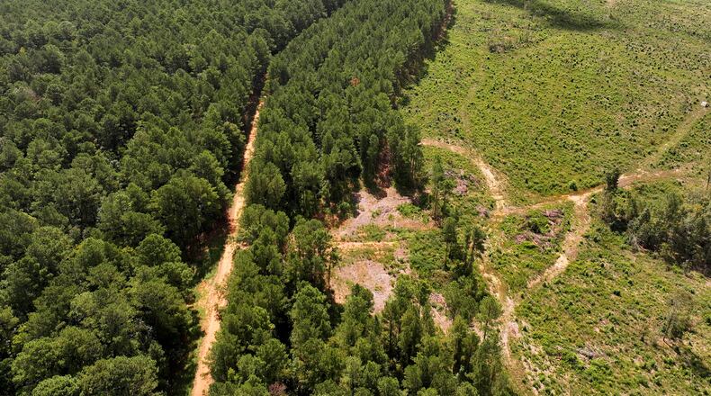 An aerial photograph shows Oaky Woods Wildlife Management Area (left) and proposed property where a solar farm was planned (right), on Tuesday, August 26, 2024, in Kathleen. (Hyosub Shin/AJC)