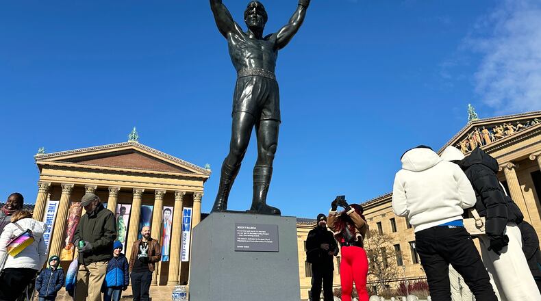 FILE - Visitors gather around the Rocky Statue during RockyFest 2024 at the Philadelphia Museum of Art, Dec. 3, 2024, in Philadelphia. (AP Photo/Tassanee Vejpongsa, File)