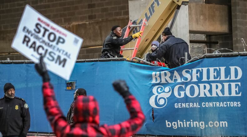 Protesters rally against Atlanta’s Public Safety Training Center at a Midtown construction site. Three people accused of trying to set fire to the Cobb office of Brasfield & Gorrie had their charges dismissed Wednesday. (John Spink/AJC 2024)