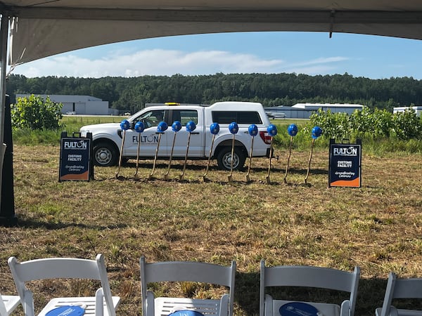 A Fulton County truck drives by before the groundbreaking ceremony for a customs facility at the Fulton County Executive Airport. (Carson Bonner/AJC)