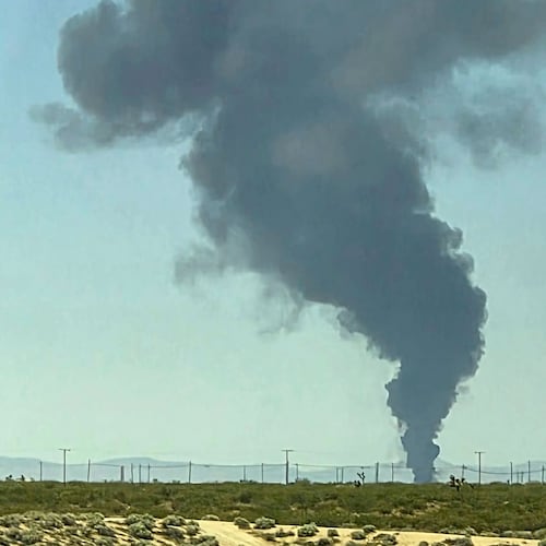 Smoke plumes rise from a B-52 bomber that crashed shortly after takeoff at a U.S. Air Force base in Southern California, Monday, June 15, 2026. (Debbie Reyes Katz via AP Photo)