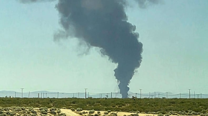 Smoke plumes rise from a B-52 bomber that crashed shortly after takeoff at a U.S. Air Force base in Southern California, Monday, June 15, 2026. (Debbie Reyes Katz via AP Photo)