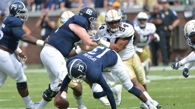 October 15, 2016 Atlanta - Georgia Southern quarterback Favian Upshaw (13) tries to hold the football as he slips in the first half at Bobby Dodd Stadium on Saturday, October 15, 2016. HYOSUB SHIN / HSHIN@AJC.COM