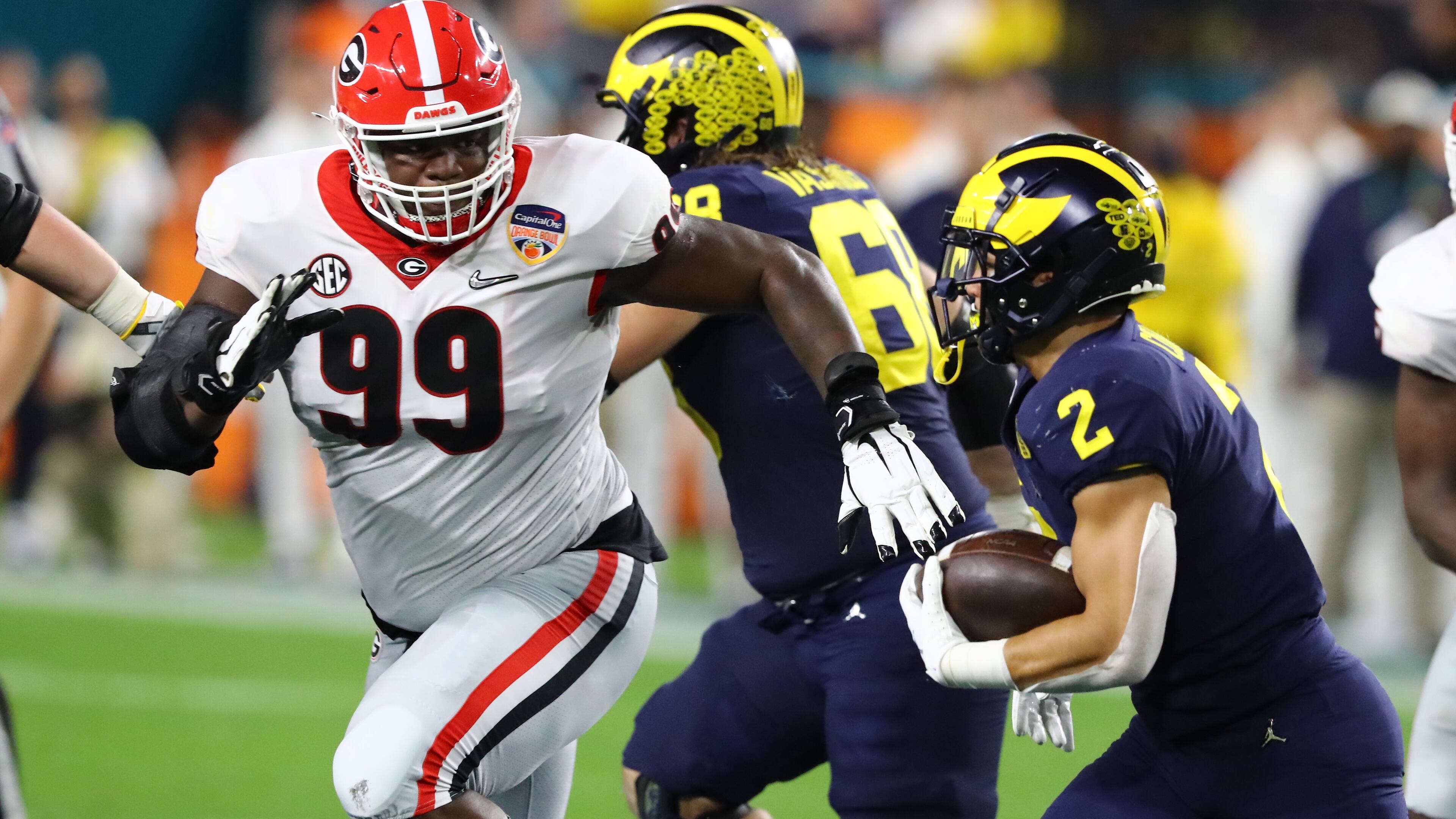 Teams from the SEC and Big Ten match up annually during bowl season, such as Georgia and Michigan in the 2021 College Football Playoffs semifinal in the Orange Bowl. Now, the SEC is considering adding Big Ten opponents during the regular season. (Curtis Compton/AJC 2021)