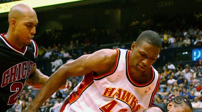 Atlanta Hawks' Theo Ratliff (42) battles Chicago Bulls' Donyell Marshall, right, and Marcus Fizer (21) for a loose ball during the fourth quarter Saturday, Nov. 2, 2002, in Atlanta. The Theo Ratliff Foundation is one of the partners for the 2018 Atlanta Peace Games.