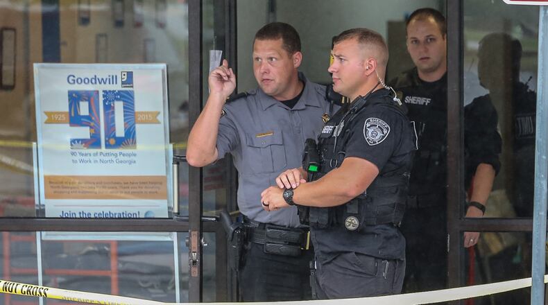 Authorities investigate a fatal shooting outside a Goodwill store in Rockdale County on Tues., Sept. 29, 2015. JOHN SPINK / JSPINK@AJC.COM