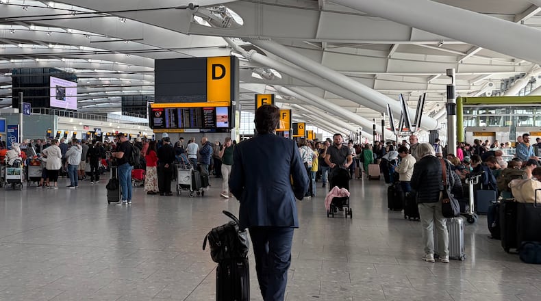 Passengers walk through Terminal 5 of London Heathrow Airport after flights were cancelled because of a technical issue in Britain's air traffic control system Tuesday, Sept. 8, 2026, in London. (Ellie Crabbe/PA via AP)