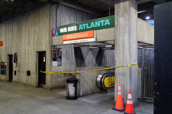 Crime scene tape stretches across an escalator at MARTA's Midtown station following a shooting Friday, June 5, 2026. (Ben Hendren for the AJC)