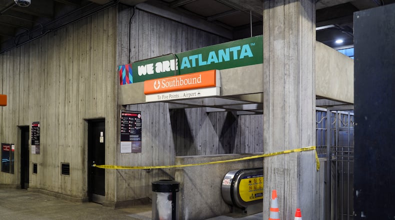 Crime scene tape stretches across an escalator at MARTA's Midtown station following a shooting Friday, June 5, 2026. (Ben Hendren for the AJC)