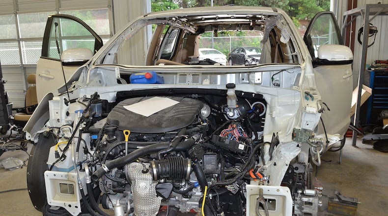 A minivan sits in the body shop at Ed Volyles Collision Center in Marietta in 2015. Insurers cite the cost of fixing vehicles damaged in accidents or storms as a factor in soaring auto insurance premiums in Georgia. (Chris Hunt/ for the AJC)
